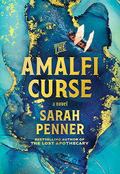 Book cover for The Amalfi Curse by Sarah Penner, featuring a woman looking out at the stunning blue sea and rugged coastline of the Amalfi Coast, with hints of mystery and historical intrigue suggesting a magical realism novel about sea witches, sunken treasure, and a timeless curse.